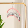 Pink curved sock drying rack with multiple clips, compact metal clip hanger for underwear. - Sakura Pink