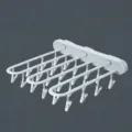 Wall-mounted folding clothes drying rack with 24 clips, perfect for socks and items. - 1 Piece/Pack / Grayish White