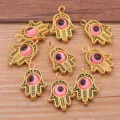 Zinc alloy Hamsa hand charms with pink evil eye design, ideal for DIY necklaces, bracelets and more. - 1 Piece Pack / Antique Gold-Pink