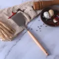 Brown silicone spatula with natural wooden handle, heat-resistant kitchen non-stick cookware tool. - Turner Spatula