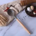 Brown silicone slotted spoon with wooden handle for non-stick cookware variant display. - Slotted Spoon