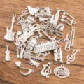 Silver alloy music charms set featuring guitars, notes, and microphones for DIY jewelry making. - Random Mixed Pack / 100g Pack
