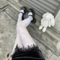 White lace fishnet tights detail view, featuring hollow out design for JK style outfits. - White