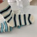 Retro gestreifte Wadensocken in Blau und Grün, Detailansicht im Vintage-College-Stil. - Einheitsgröße / Weiß