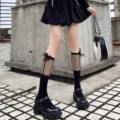 Detailed shot of black mesh spliced calf socks with cute bows for Lolita JK style outfits. - One Size / Black