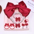 Kids red bow pearl jewelry set details, featuring necklace bracelet hair clips and cute rings. - Gift Box / Red