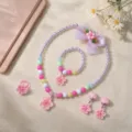 Close up detail of kids princess style beaded necklace bracelet ring and flower hair clip set. - Peach Pink 6-Piece Set (Transparent Bag)
