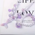 Detailed view of the children pearl necklace and seashell bracelet set with mermaid theme. - Mermaid Tail 2-Piece Set (Cardboard Packaging) / Purple