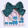 Detailed view of children jewelry set with green bow hair clip and pearl necklace. - Gift Box / Dark Green
