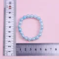 Close-up detail of blue cracked bead bracelet, 8mm beads, 16mm circumference showcase. - Blue