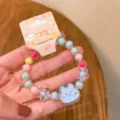 Detailed close-up of cute kids jelly beaded bracelet with adorable cartoon pendant for girls. - Cloud Rabbit