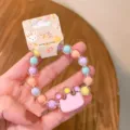 Detailed view of children's colorful jelly bead bracelet with crown pendant and card. - Cute Crown