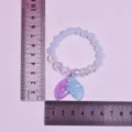 Detailed close-up view of the children's beaded bracelet featuring a cute mermaid tail pendant. - Purple-Blue Gradient Mermaid Tail Bracelet