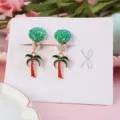 Children's cute clip-on earrings featuring glitter green round tops and tropical palm tree charms. - Palm Tree