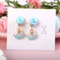 Cute children clip-on earrings detail featuring blue pearl stud and seashell pendant design. - Double Color Shell