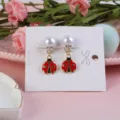 Cute red ladybug and white pearl clip-on earrings for kids, charming alloy jewelry detail. - Beetle
