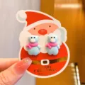 Cute blue bear clip-on earrings for kids with pink scarf design on Santa Claus display card. - Bear with Scarf