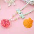 Kids ocean style pearl necklace with pink glitter seashell pendant and cute bow accessories. - Watermelon Red Quicksand Shell Necklace (1 Piece, Polybagged)