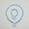 Blue beaded necklace and bracelet set for kids with cute butterfly bowknot design. - Butterfly Necklace 2-Piece Set / Clear Bag Packaging / Light Blue