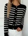 Close-up detail of women's black and white striped knit cardigan featuring elegant gold buttons. - One Size / Black