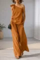 Detail view of the elegant one shoulder sleeveless top and wide leg pants in caramel. - Caramel color