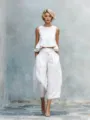 White linen blend two piece set featuring a sleeveless ruffle crop top and wide leg pants. - S / White