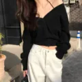 Details of women's black V-neck knit sweater showcasing the chic neckline and soft fabric. - One Size / Tops / Black