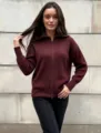 Detailed close-up of a stylish burgundy zip-up knit cardigan sweater showing ribbed texture. - One Size / Dark Red