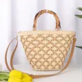 Detailed view of women straw woven crossbody bag with bamboo handle and casual hollow design. - Beige