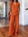 Detail view of a solid color summer casual two-piece set featuring V-neck top and wide pants. - Orange Red