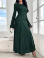 Detailed view of the elegant dark green long-sleeve slim pleated maxi dress in setting. - XS / Green