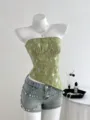 Close-up detail of the elegant green sequin textured strapless tube top on mannequin display. - M / Tops / Green