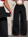 Detail shot of trendy women's black denim wide-leg pants with asymmetrical high waist design. - S / Bottoms / Black