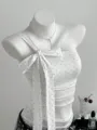 Detailed view of the white polka dot one shoulder bow strap top with delicate lace trim. - S / Tops / White