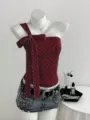 Detailed view of dark red polkadot one-shoulder top with elegant bow and chic denim skirt. - S / Tops / Burgundy