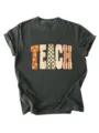 Detailed view of women's short sleeve teacher graphic tee with vintage floral letter print. - S / Tops / Dark Gray