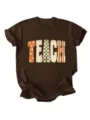 Detailed close-up of brown short sleeve t-shirt with retro TEACH typography print. - S / Tops / Coffee