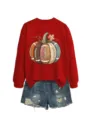 Womens red long sleeve sweatshirt paired with denim shorts featuring a football pumpkin graphic. - S / Tops / Red