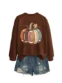 Detailed view of the brown sweatshirt featuring creative football pumpkin graphic and denim shorts. - S / Tops / Coffee