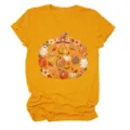 Detailed view of the cute autumn pumpkin and ghost graphic printed on the yellow t-shirt. - S / Tops / Mustard Yellow