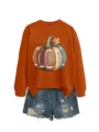 Close-up detail of the creative autumn football pumpkin graphic print on this orange sweatshirt. - S / Tops / Burnt Orange