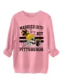Close-up detail of pink long sleeve graphic sweatshirt featuring funny skull print. - S / Tops / Peach