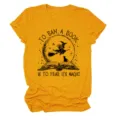 Close-up detail of the mustard yellow witch book graphic short sleeve crewneck t-shirt. - S / Tops / Mustard Yellow (Black Text)