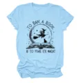 Light blue short sleeve crewneck graphic t-shirt detail showing witch and book print - S / Tops / Light Blue (Black Text)