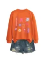 Close-up detail view of the cute radiology theme print graphic on the orange long sleeve sweatshirt. - S / Tops / Orange