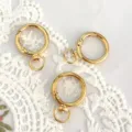 Gold round spring snap hooks close-up view, durable alloy keychain hardware for DIY crafts. - Round Style / Gold