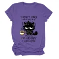 Detailed view of casual women short sleeve graphic t-shirt featuring funny grumpy cat print. - S / Tops / Purple (Black Text)