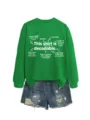Green crewneck sweatshirt featuring educational linguistic text paired with denim shorts. - S / Tops / Grass Green Sweatshirt (White Font)