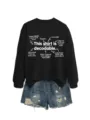 Detailed view of the black graphic sweatshirt with educational linguistic print and denim shorts. - S / Tops / Black (White Font)