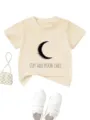 Close-up detail of beige kids short sleeve t-shirt featuring a crescent moon and text graphic. - Apricot